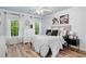Cozy bedroom with a tufted headboard, hardwood floors, and plenty of natural light at 903 Shaftoe Nw St, Kennesaw, GA 30152