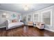 Bright room features hardwood floors, a daybed, plush seating, and natural light at 903 Shaftoe Nw St, Kennesaw, GA 30152