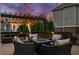 Backyard deck features comfortable outdoor seating and a pergola adorned with string lights for evening gatherings at 903 Shaftoe Nw St, Kennesaw, GA 30152