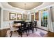 Elegant dining room with tray ceiling, wainscoting, and large windows, perfect for hosting dinner parties at 903 Shaftoe Nw St, Kennesaw, GA 30152