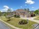 Beautiful two-story brick home with a three-car garage and a well-manicured lawn at 903 Shaftoe Nw St, Kennesaw, GA 30152