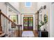 Elegant foyer features a dark wood staircase, double doors, and a modern sliding barn door for added privacy at 903 Shaftoe Nw St, Kennesaw, GA 30152