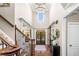 Grand foyer with soaring ceilings, elegant chandelier, and hardwood floors, creating a welcoming entrance at 903 Shaftoe Nw St, Kennesaw, GA 30152