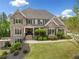 Charming brick home with manicured lawn and stately curb appeal, perfect for luxurious living at 903 Shaftoe Nw St, Kennesaw, GA 30152