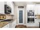 Bright kitchen boasts stainless steel appliances, granite countertops, and a pantry at 903 Shaftoe Nw St, Kennesaw, GA 30152