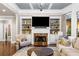 Inviting living room with a marble fireplace, built-in shelves, and ample seating creates a perfect gathering space at 903 Shaftoe Nw St, Kennesaw, GA 30152