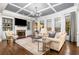 Bright, spacious living room with coffered ceiling, built-in shelves, and a cozy fireplace creates an inviting atmosphere at 903 Shaftoe Nw St, Kennesaw, GA 30152