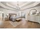 Spacious main bedroom with tray ceilings, hardwood floors, sitting area, and decorative touches at 903 Shaftoe Nw St, Kennesaw, GA 30152