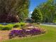The Highlands at Hamilton Mill community sign surrounded by colorful flowers and lush landscaping at 903 Shaftoe Nw St, Kennesaw, GA 30152