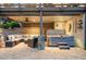 Outdoor patio includes a hot tub, stone pillars, and a comfortable seating area under a wood pergola at 903 Shaftoe Nw St, Kennesaw, GA 30152