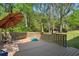 Backyard deck with chairs and a small pool, surrounded by trees and greenery at 1649 Clairmont Ne Way, Brookhaven, GA 30329