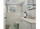 Bathroom with white tile walls, vanity with marble countertop, mirror, toilet, and window at 1649 Clairmont Ne Way, Brookhaven, GA 30329