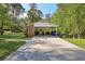 Carport with a long driveway and a well-kept lawn extending to the backyard at 1649 Clairmont Ne Way, Brookhaven, GA 30329