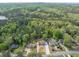 Expansive aerial view showcases the home's location amidst lush greenery and near a tranquil lake at 2619 Kellogg Creek Rd, Acworth, GA 30102