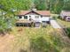 Home boasts a large backyard with a deck, hot tub, and mature trees at 2619 Kellogg Creek Rd, Acworth, GA 30102
