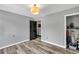 Bright bedroom with modern gray paint, beautiful laminate floor and doors leading to additional storage space at 2619 Kellogg Creek Rd, Acworth, GA 30102