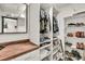 Organized walk-in closet with custom shelving and storage for clothing and accessories, wood countertop at 2619 Kellogg Creek Rd, Acworth, GA 30102