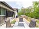 Outdoor deck with a dining table, chairs, backyard view, and a mounted TV for outdoor entertainment at 2619 Kellogg Creek Rd, Acworth, GA 30102