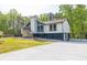 Stylish home with a prominent chimney, gated driveway, and a spacious concrete pad at 2619 Kellogg Creek Rd, Acworth, GA 30102