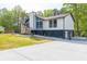A beautifully renovated home featuring an intricate front patio and a secure gated driveway at 2619 Kellogg Creek Rd, Acworth, GA 30102