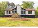 Charming home exterior featuring a quaint front porch, black trim, and a well-manicured lawn at 2619 Kellogg Creek Rd, Acworth, GA 30102