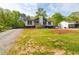Home featuring a green lawn and mature trees at 2619 Kellogg Creek Rd, Acworth, GA 30102