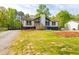 Well-kept lawn and manicured flowerbeds frame this charming home at 2619 Kellogg Creek Rd, Acworth, GA 30102