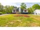 Charming home on a lush green lawn, surrounded by mature trees at 2619 Kellogg Creek Rd, Acworth, GA 30102