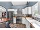 Bright kitchen features stainless steel appliances, white cabinetry, butcher block counters and ceramic backsplash at 2619 Kellogg Creek Rd, Acworth, GA 30102