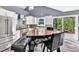 Bright kitchen with stainless steel appliances, white cabinets, and an attached wooden dining table at 2619 Kellogg Creek Rd, Acworth, GA 30102