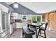 Well-lit kitchen featuring stainless steel appliances, white cabinetry, barn door, and an informal dining area at 2619 Kellogg Creek Rd, Acworth, GA 30102