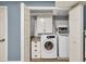 Laundry room featuring a washer, dryer, built-in cabinets, granite-look countertops, and a storage cabinet at 2619 Kellogg Creek Rd, Acworth, GA 30102