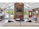 Stylish living area filled with light, wood fireplace, modern couch, vaulted ceilings at 2619 Kellogg Creek Rd, Acworth, GA 30102