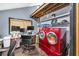 Versatile home office with laundry and desk setup, ideal for work and chores with rustic beams overhead at 2619 Kellogg Creek Rd, Acworth, GA 30102