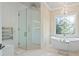Elegant bathroom with a walk-in shower, standalone tub, and decorative window at 2990 Byrons Green Ct, Marietta, GA 30062