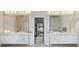 Bright bathroom featuring dual vanities with mirrors and lighting, and glass enclosed shower, with view into bedroom at 2990 Byrons Green Ct, Marietta, GA 30062