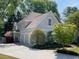 View of home with a large driveway leading to a three-car garage, complemented by lush landscaping at 2990 Byrons Green Ct, Marietta, GA 30062