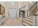 Elegant foyer with hardwood floors, staircase, and decorative columns leading to a bright entryway at 2990 Byrons Green Ct, Marietta, GA 30062