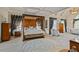 Spacious bedroom with a canopy bed, hardwood floors, and luxurious decor at 2990 Byrons Green Ct, Marietta, GA 30062