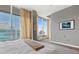 Serene main bedroom featuring large windows with cityscape views, hardwood floors, and neutral tones at 943 Peachtree Ne St # 2002, Atlanta, GA 30309