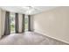 Bedroom featuring neutral walls, carpet, and a ceiling fan and three windows with coverings at 2009 Shipwreck Ct, Buford, GA 30518