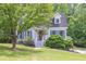 Quaint two-story home featuring white siding and a welcoming front porch at 2009 Shipwreck Ct, Buford, GA 30518