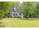Charming two-story home with a lush green lawn and mature trees at 2009 Shipwreck Ct, Buford, GA 30518