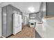 Stylish kitchen featuring gray cabinets, stainless appliances, subway tile backsplash, and wood-look floors at 2009 Shipwreck Ct, Buford, GA 30518