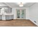 Bright eat-in kitchen with gray cabinets, light countertops, wood-look floors, and access to the back deck at 2009 Shipwreck Ct, Buford, GA 30518
