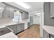 Bright kitchen featuring gray cabinets, stainless appliances, and views into the eat-in kitchen and back deck at 2009 Shipwreck Ct, Buford, GA 30518