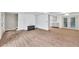 Open living space with hardwood floors, fireplace, and access to the kitchen and deck at 2009 Shipwreck Ct, Buford, GA 30518