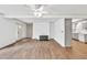 Bright living room with wood floors, a ceiling fan, and an open layout to the kitchen at 2009 Shipwreck Ct, Buford, GA 30518