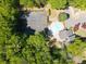 Aerial view of tennis courts, swimming pool and clubhouse surrounded by mature trees at 2102 Palmyra Se Dr, Marietta, GA 30067