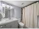 Clean bathroom featuring a tub with shower, gray vanity and unique tile design at 2102 Palmyra Se Dr, Marietta, GA 30067